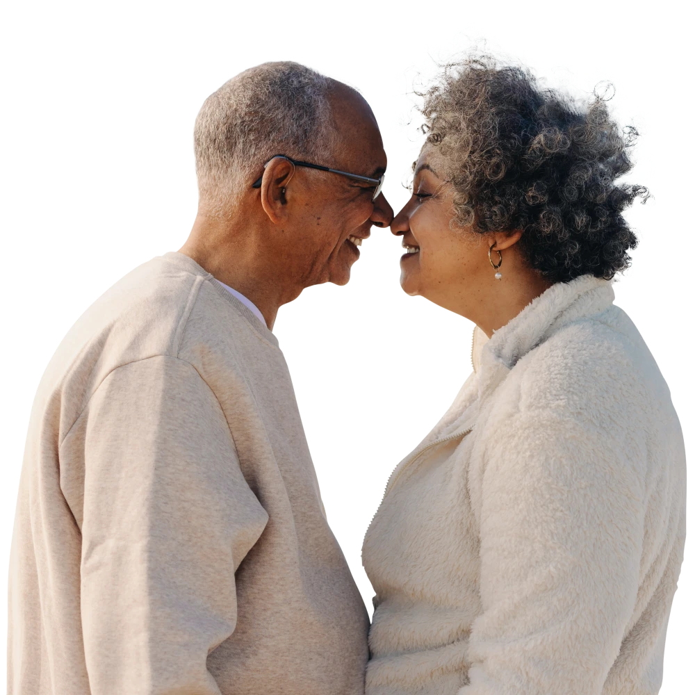 Elderly couple smiling affectionately while touching noses